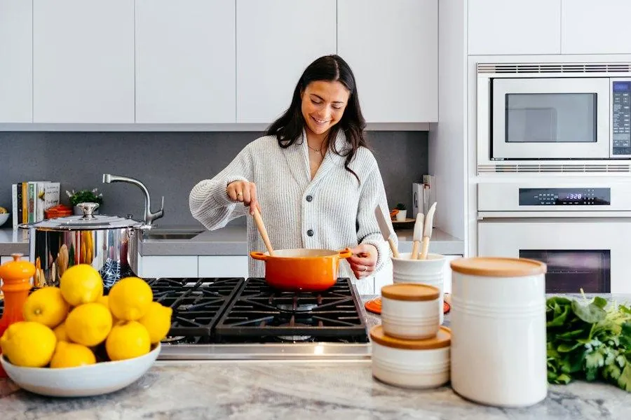 Woman cooking at the stove in a bright kitchen